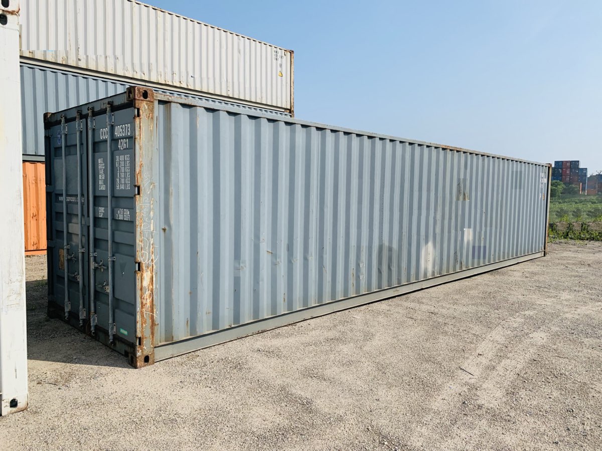A steel shipping container placed on a lot for scrap tire collection