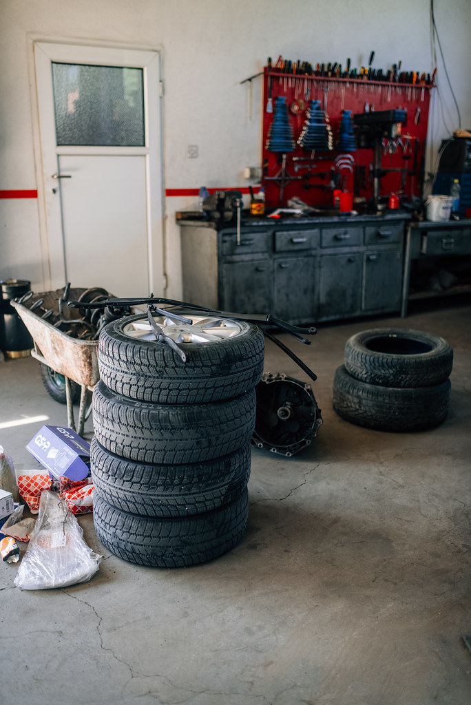 Stacked tires inside a workshop awaiting removal