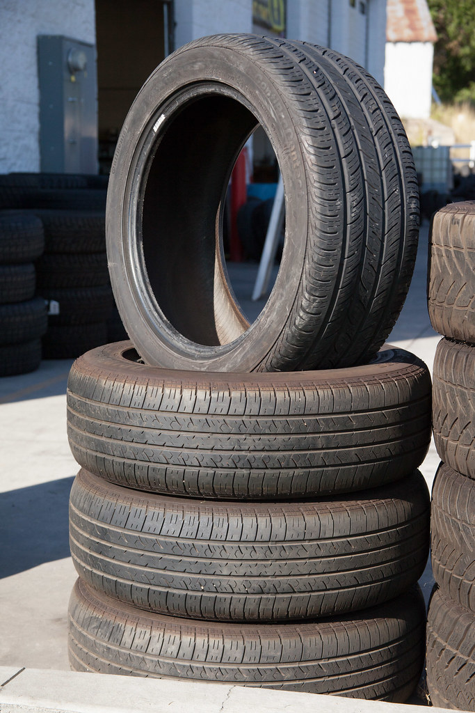 A stack of used car tires at a drop-off yard